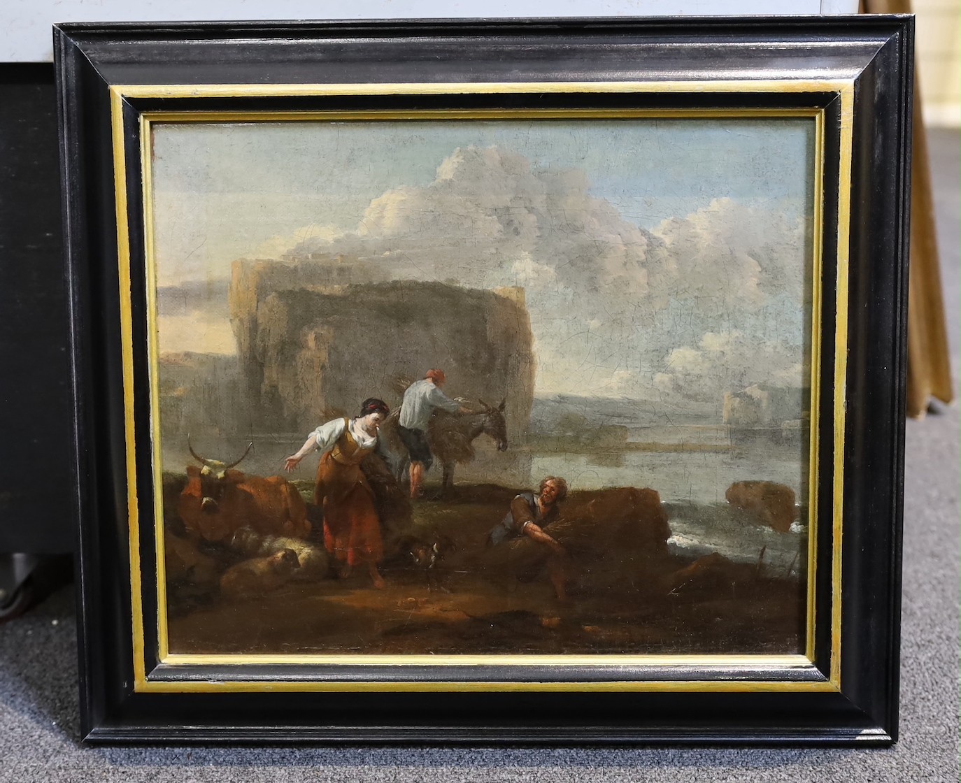 Nicholaes Bercham (Dutch, 1620-1683), A landscape with figures and animals on the shores of a lake, a mountainous cliff with buildings beyond, oil on canvas, 30 x 37cm